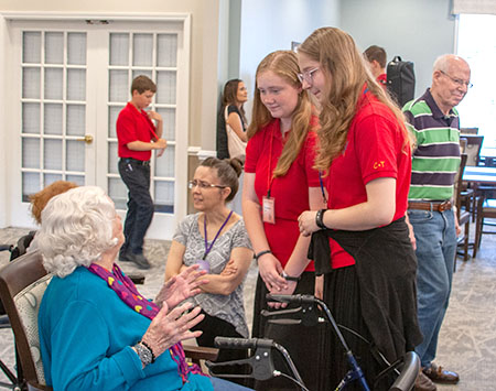 girls talking with woman with walker