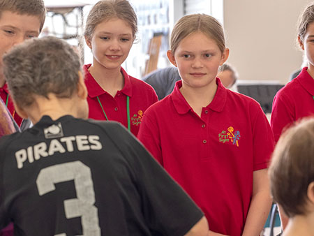 girls talking with man in black shirt