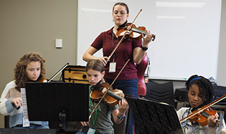 violin teacher and 3 students