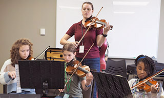 violin teacher and 3 students