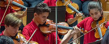 Young people playing violins
