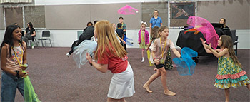 Children tossing scarves