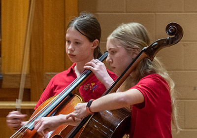 two girls playing cello