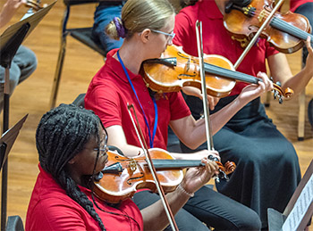 two girls playing violin