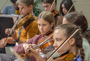 Young people playing violins