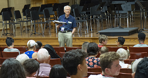 man leading singing group