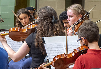 girls playing violins