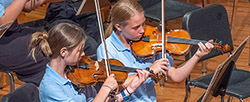 two girls playing violins