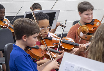 boys playing violins