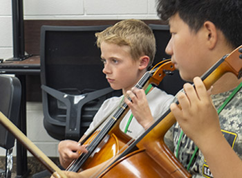 two boys playing cello