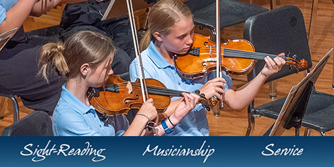 two girls playing violin