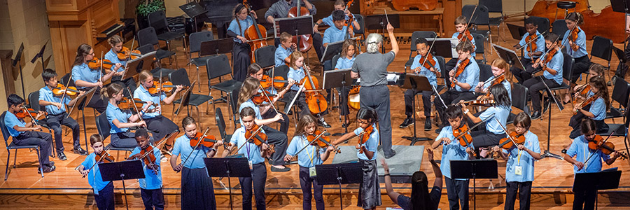 children playing string instruments together