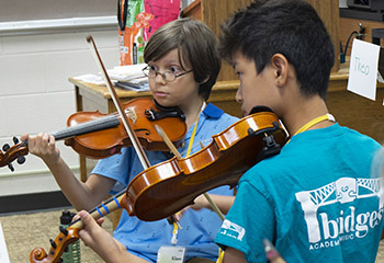 two boys playing violins