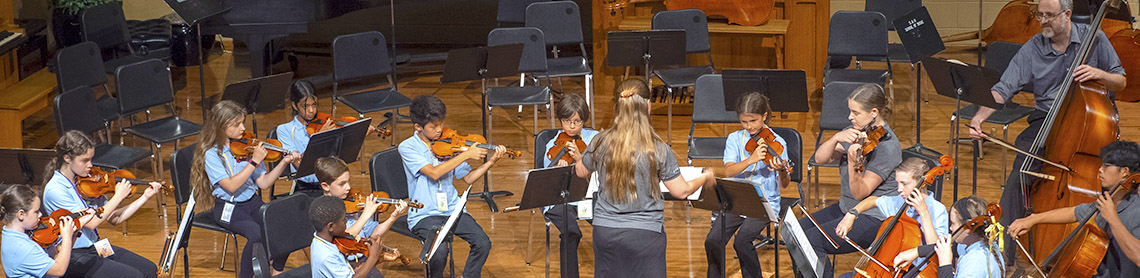 Young children playing strings