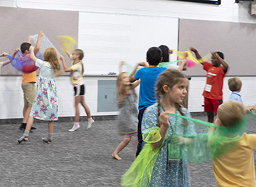 Children playing with scarves