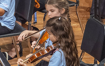 two girls playing violins