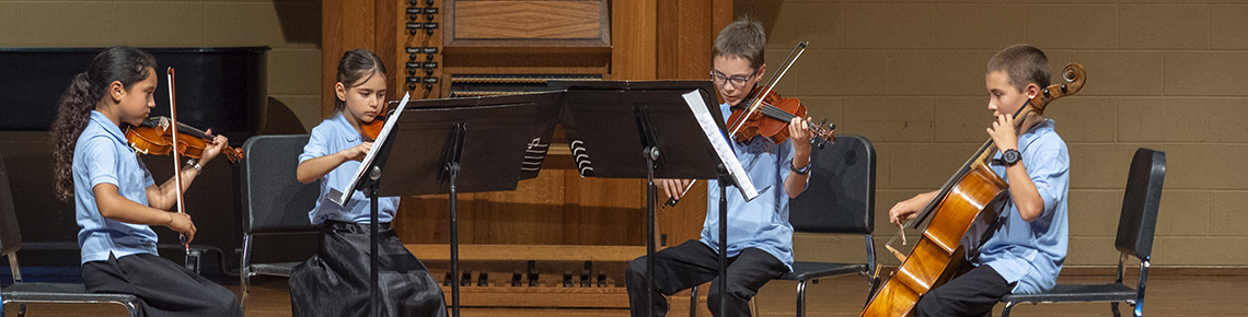 children playing a string quartet