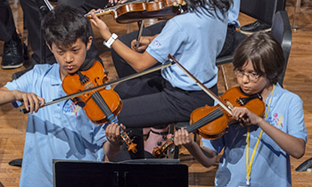 two boys playing violins