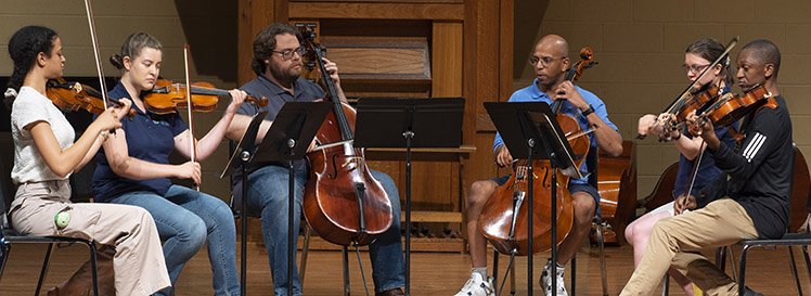 faculty members playing string quintet