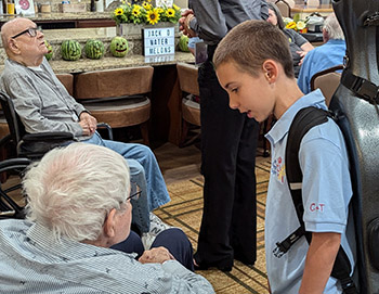 boy talking to man in wheelchair