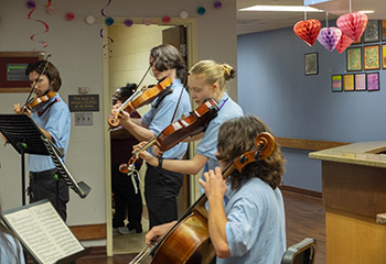 young people playing music in a nursing home