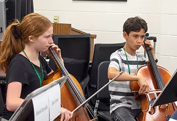 2 children playing cello