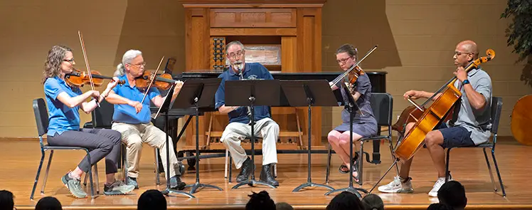 musicians playing clarinet quartet