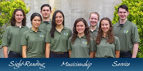 8 young people in green shirts